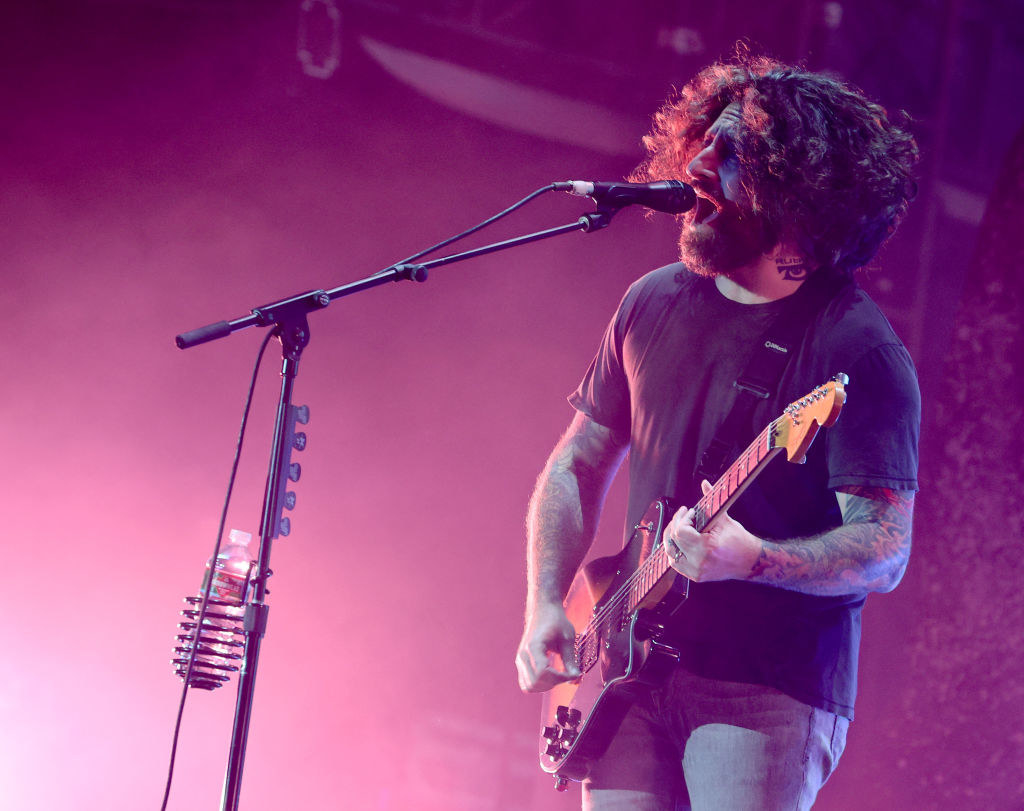 Joe singing and playing guitar on stage