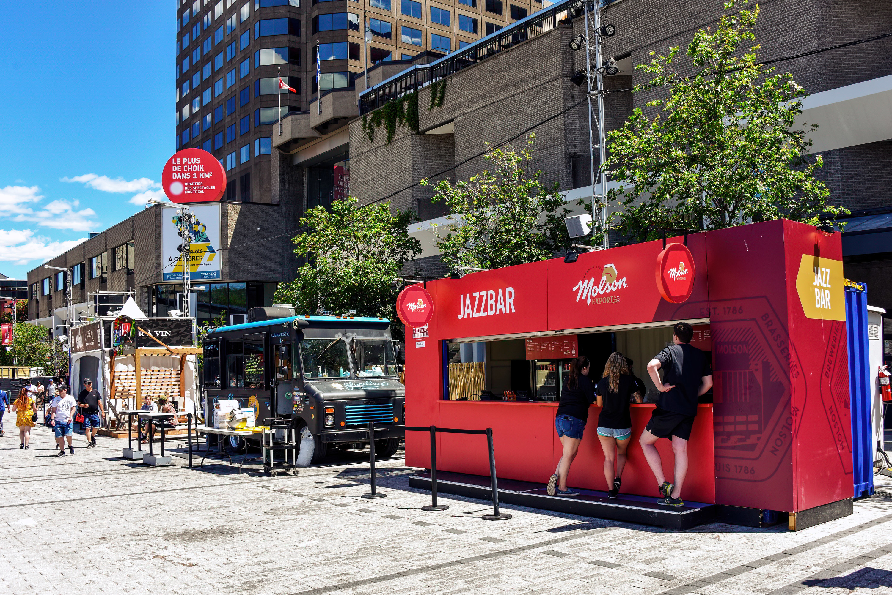 People shop at Kiosks selling food, beer and wine on Saint-Catherine Street during the annual Montreal Jazz Festival a popular tourist attraction.