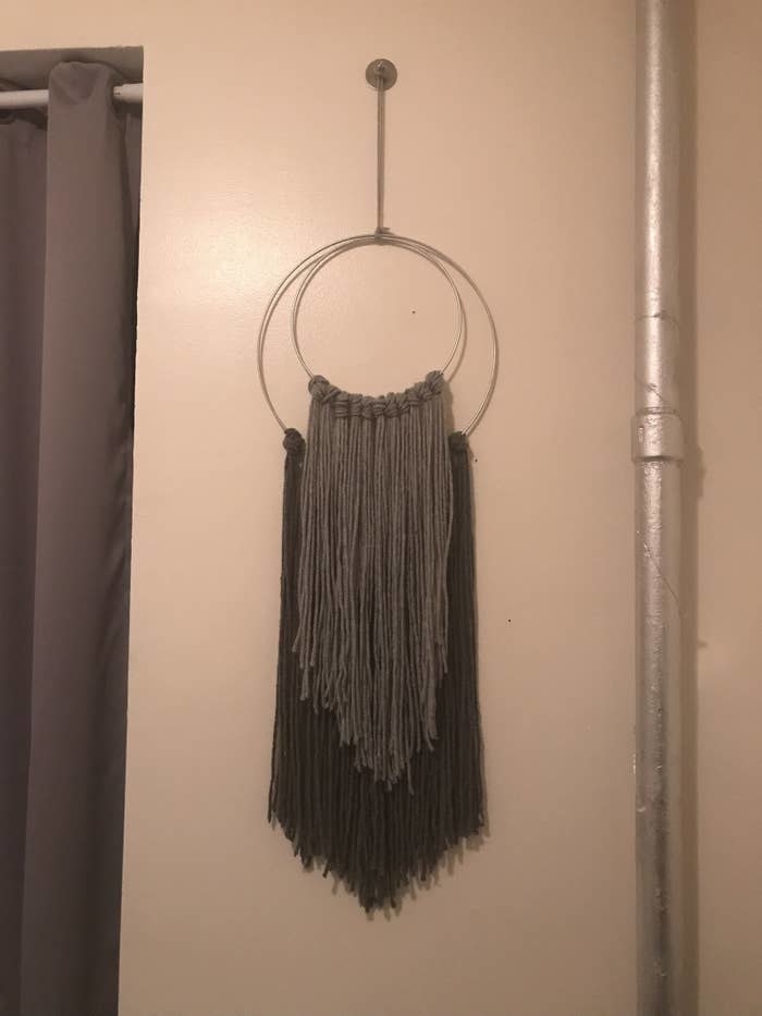 yarn hanging from different sized hoops on a wall
