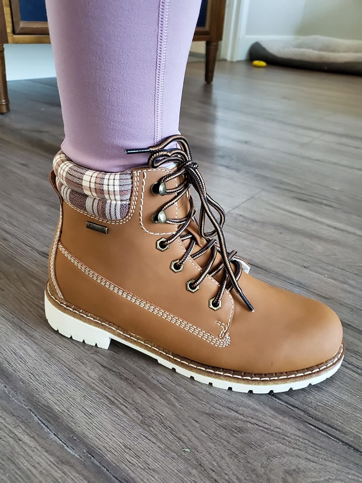Reviewer wearing boot with purple leggings