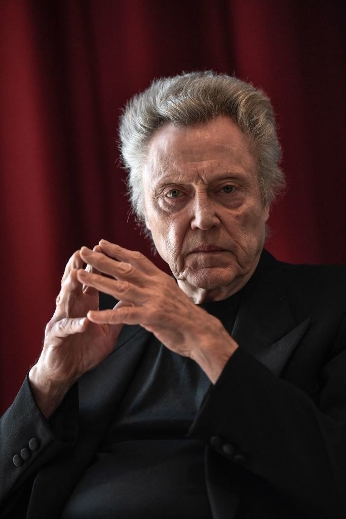 Walken sitting with his hands together
