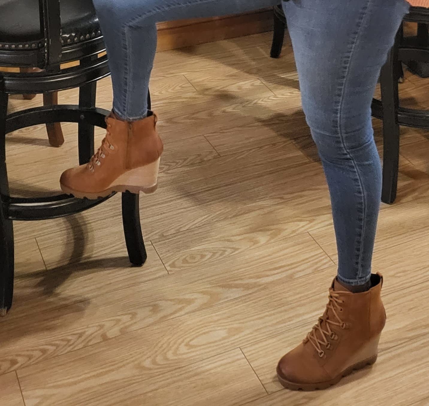 Reviewer wearing brown wedge boots and jeans