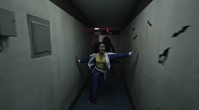 Girl being chased down a hallway
