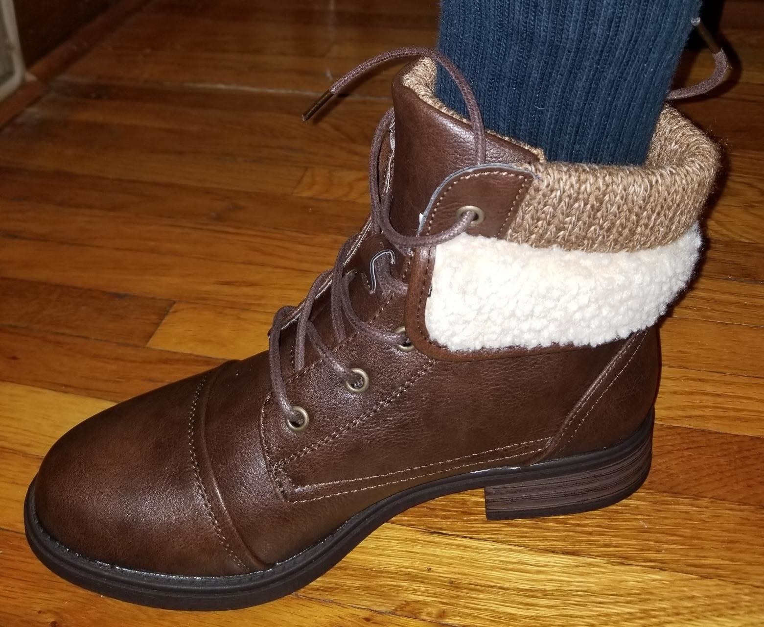 Reviewer wearing brown boot
