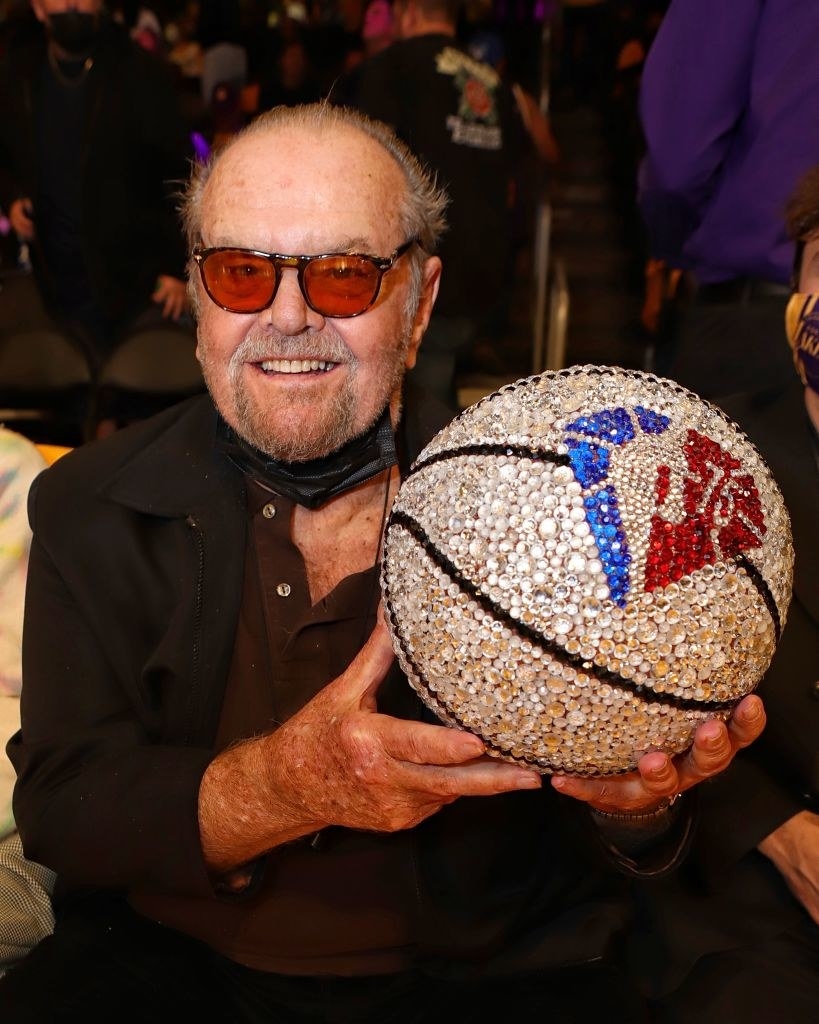 Nicholson holding a bejeweled basketball