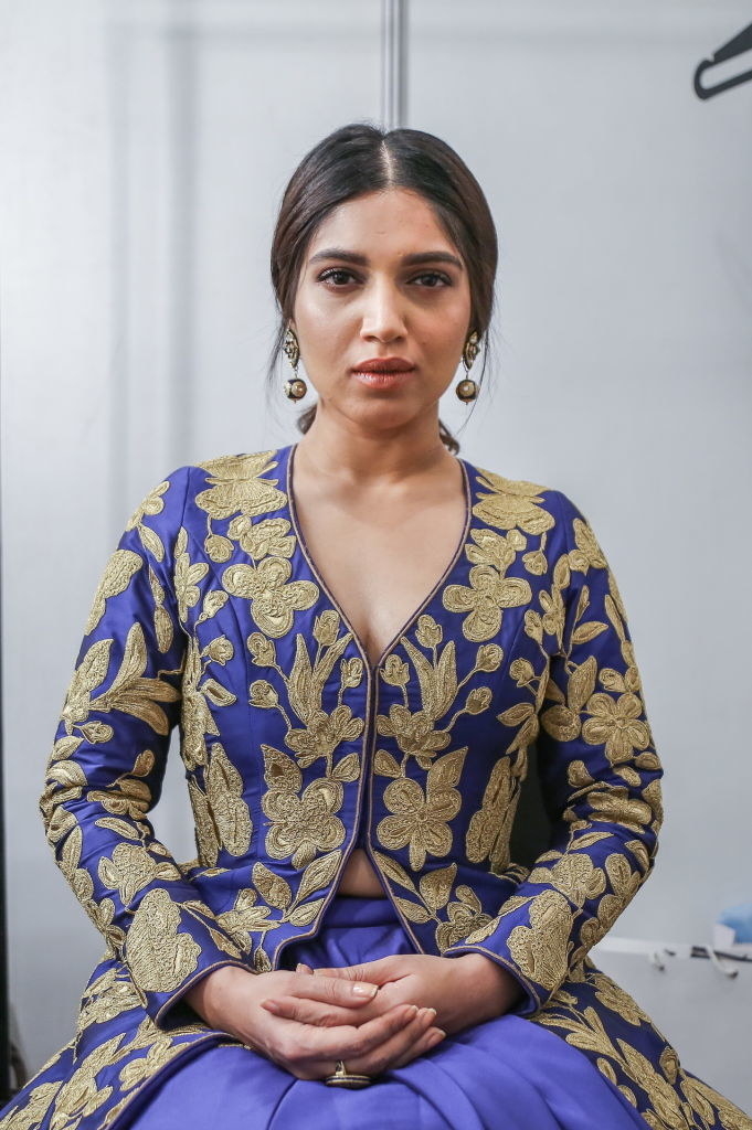 Bhumi, wearing a brocade dress, poses with hands folded