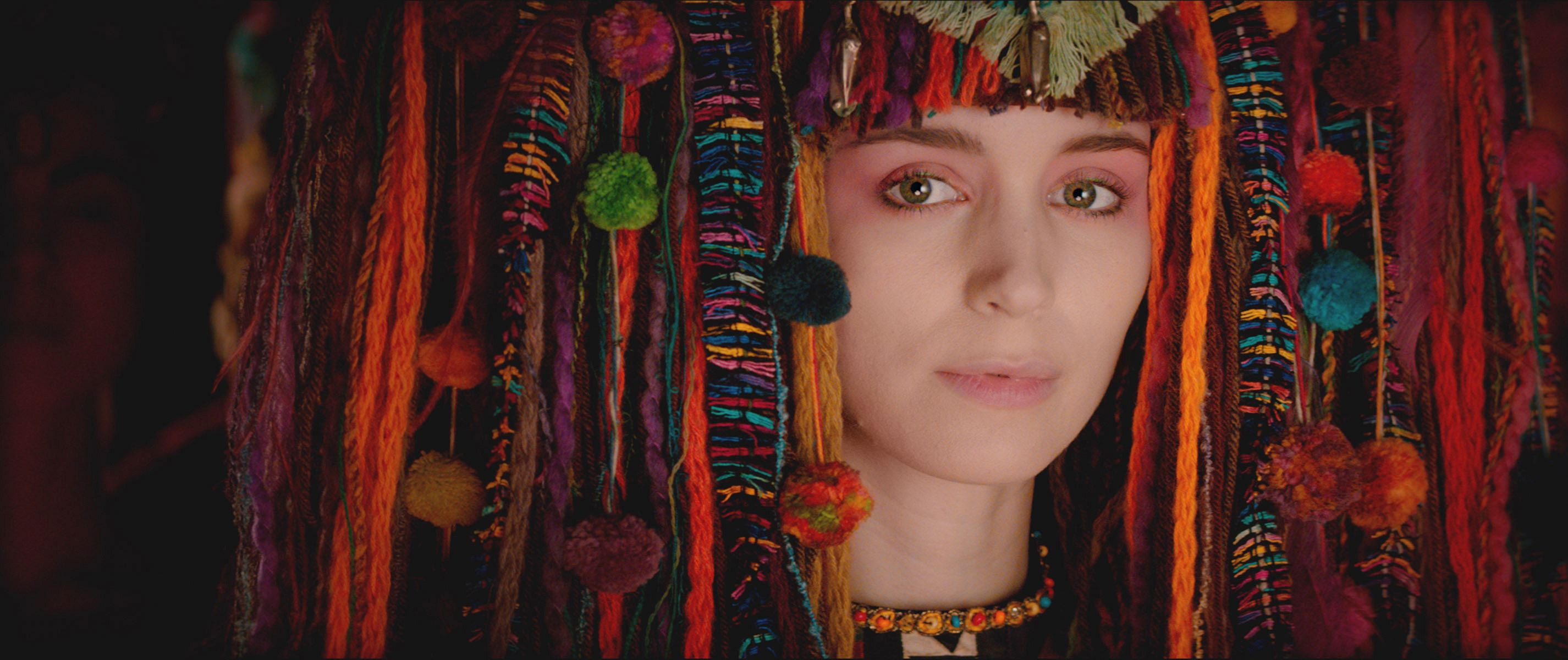 close up of Mara in a large headpiece