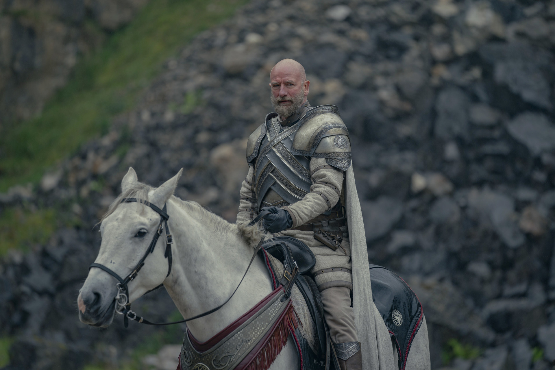 Harrold Westerling wears armor and sits on a white horse
