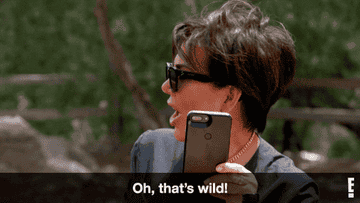 Kris Jenner looking at a cellphone and saying &quot;Oh, that&#x27;s wild!&quot;