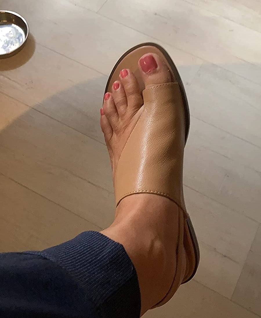 Reviewer wearing tan leather sandals
