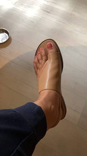 Reviewer wearing tan leather sandals