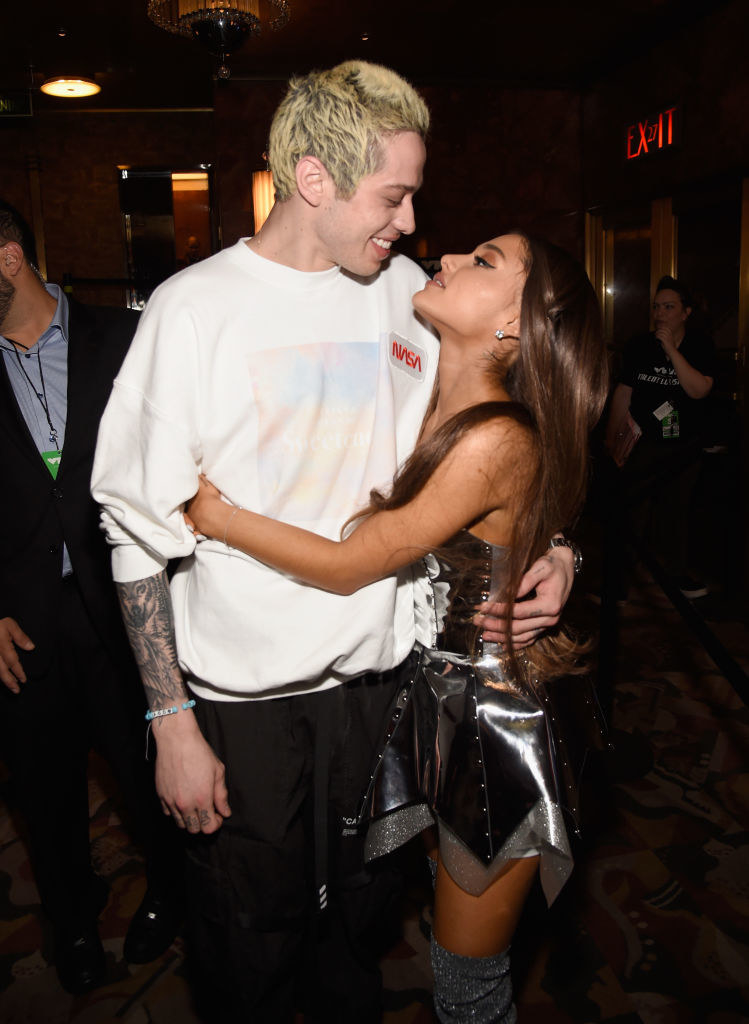 Ariana and Pete looking at each other while holding each other at an event