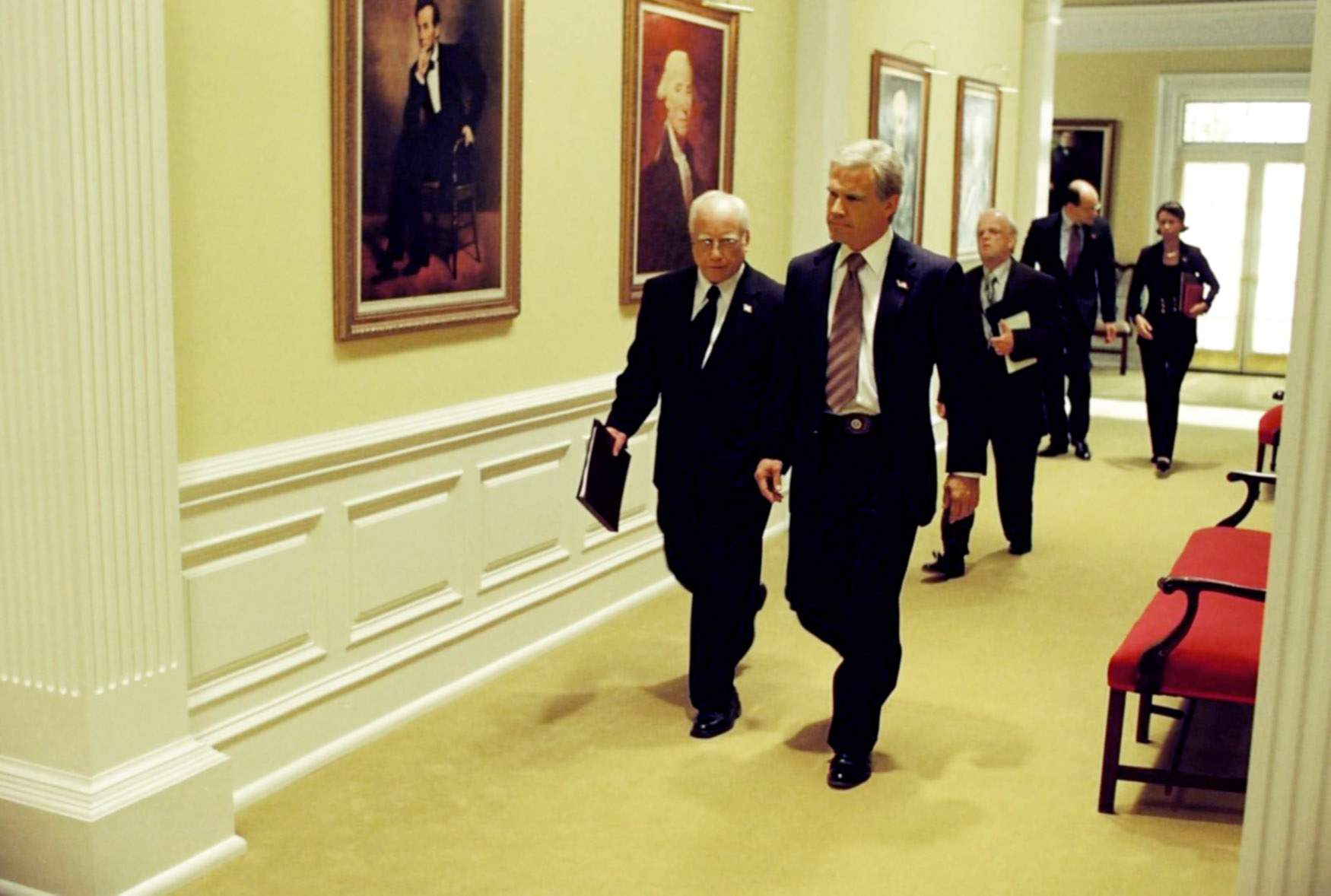 scene from the movie with characters walking in the hallway of the white house