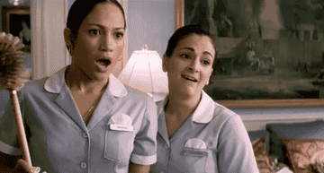 Jennifer Lopez as a maid gasping at something with a fellow maid