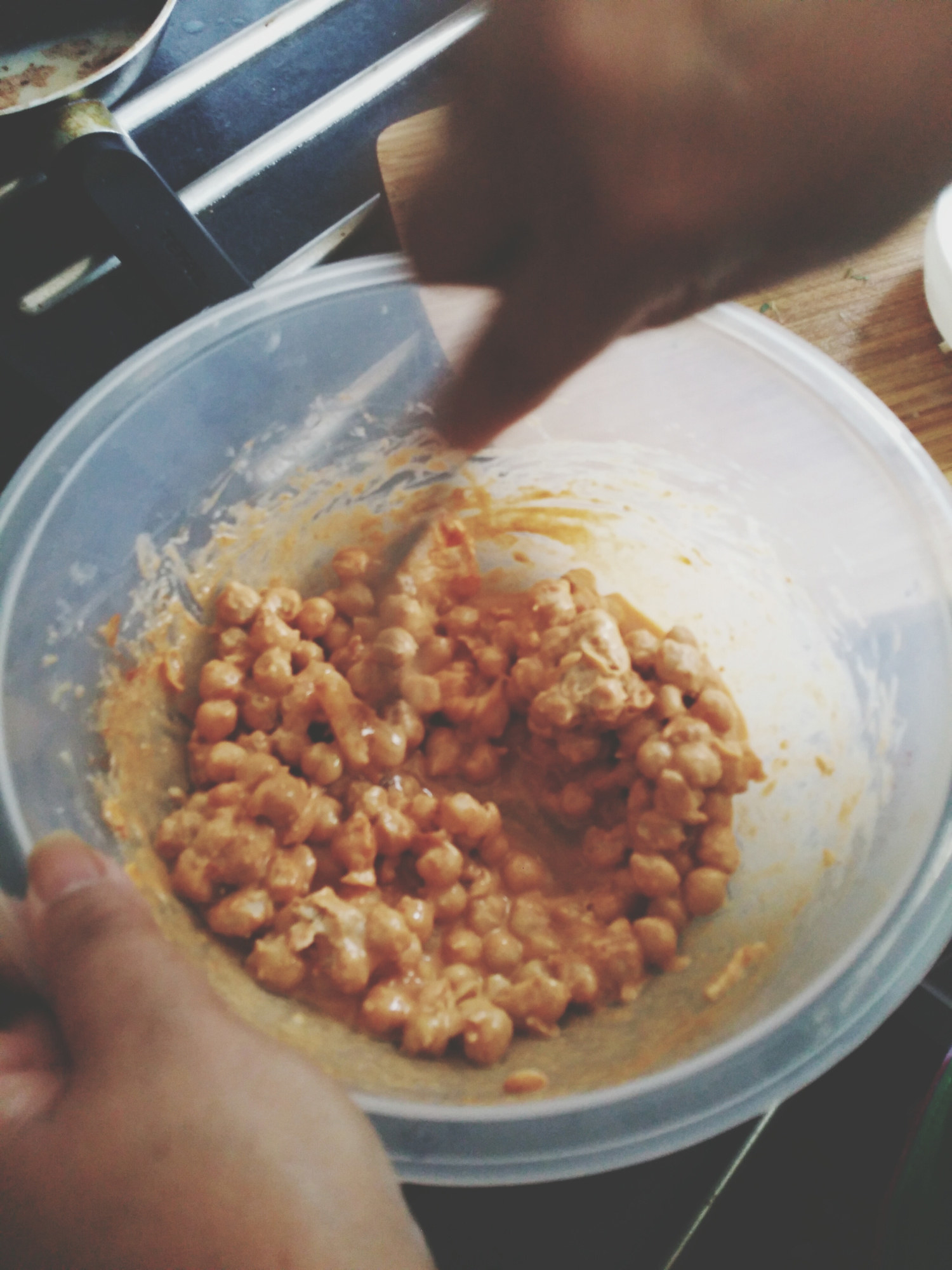 A person stirring chickpeas