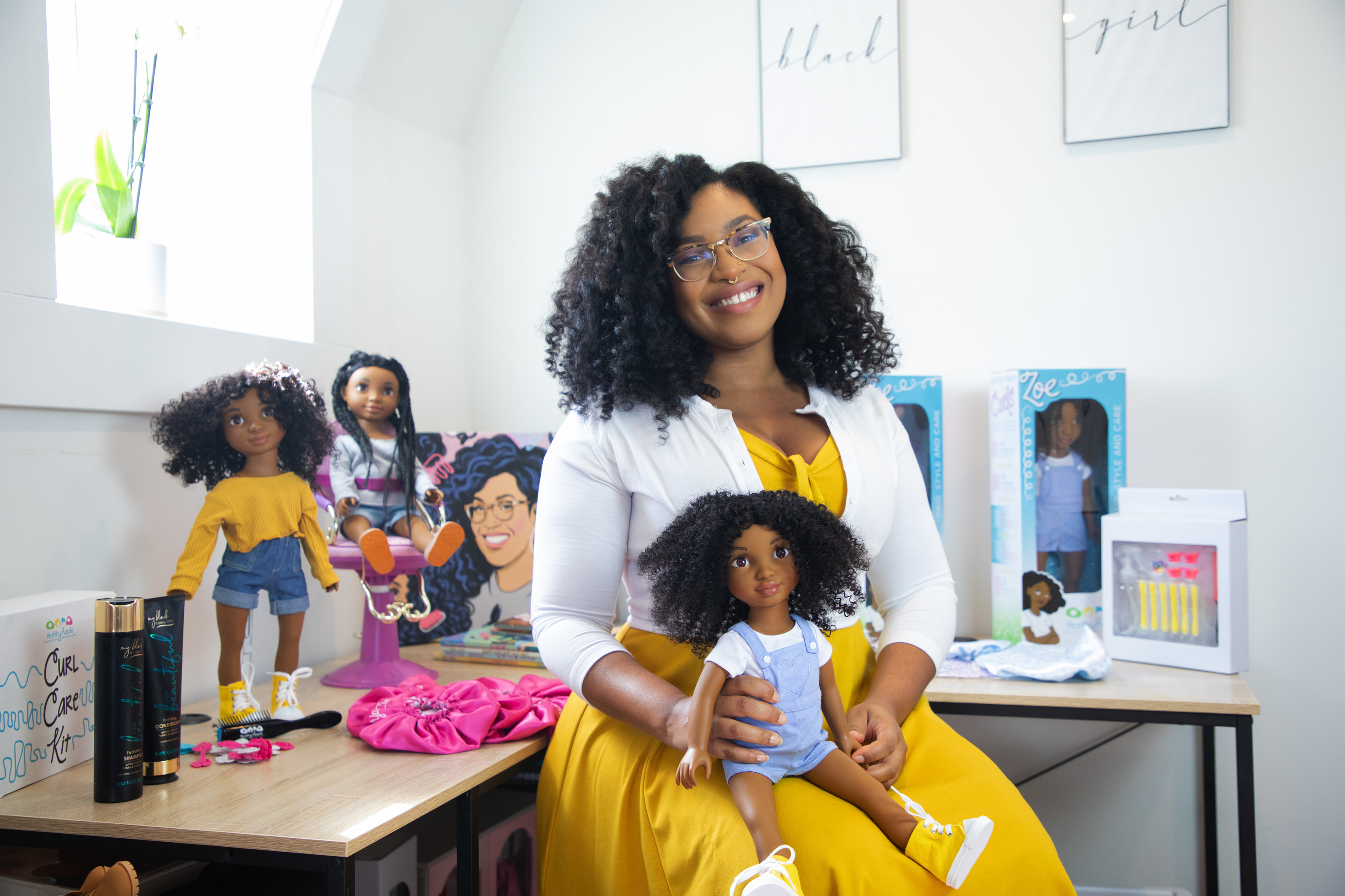 Yelitza with her Zoe doll in an office