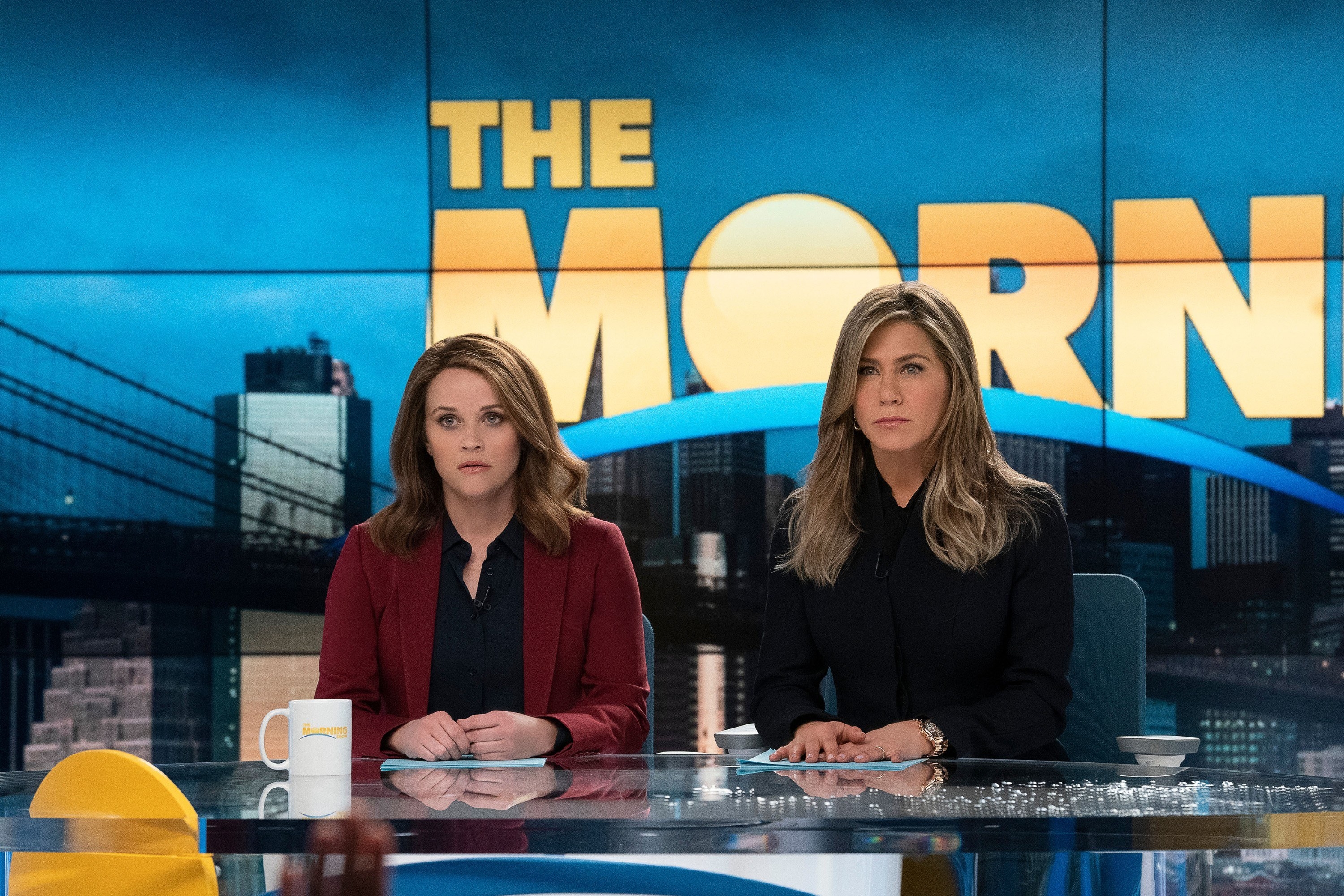 Reese and Jennifer&#x27;s characters sit behind the anchor desk