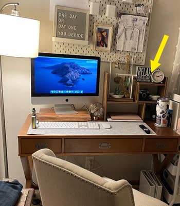 a reviewer shows the full of their desk with the brown shelves
