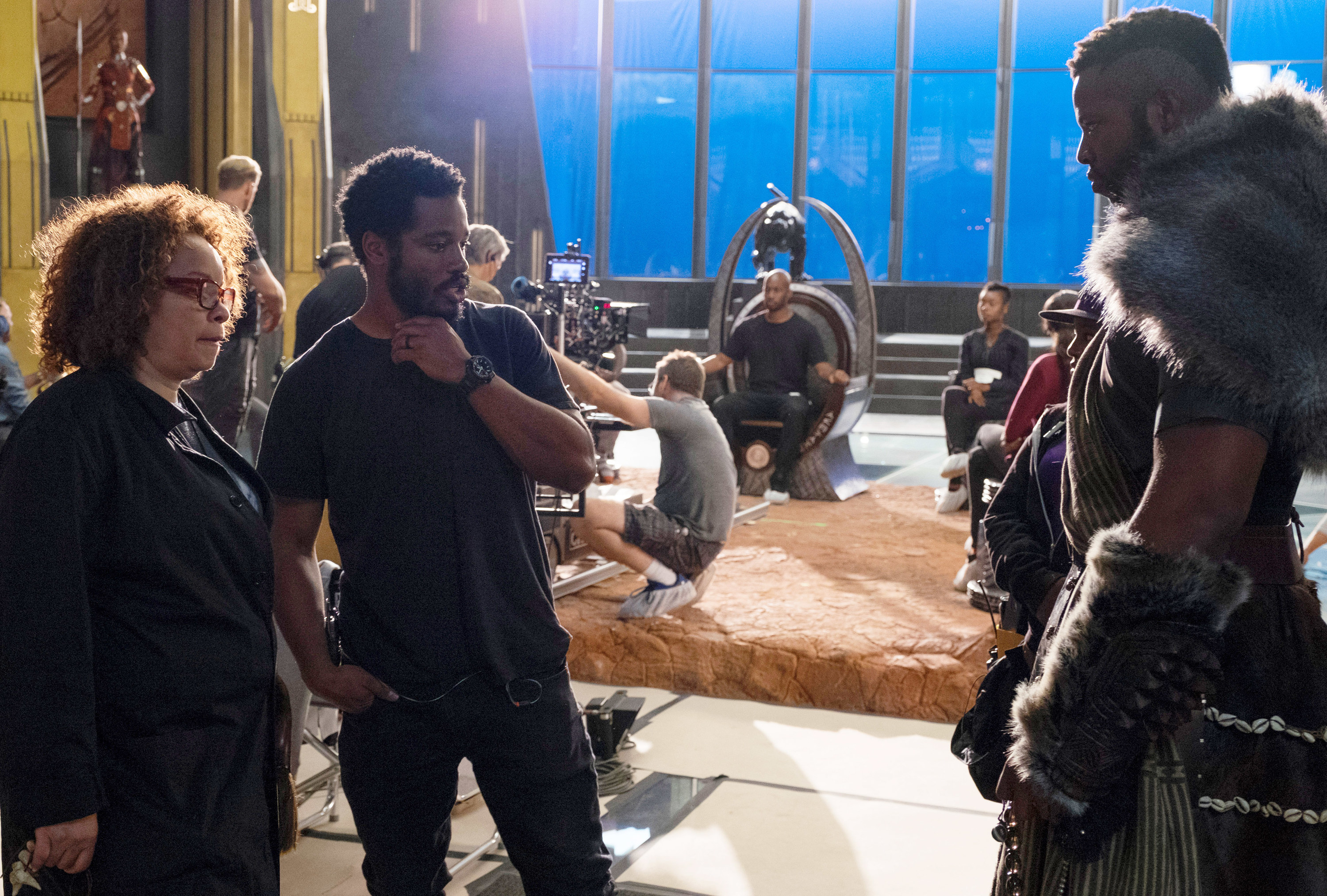 Coogler and Ruth on set looking over costumes