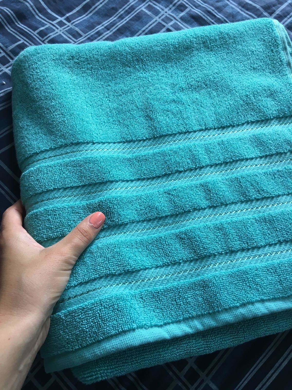 a reviewer holding the teal towel