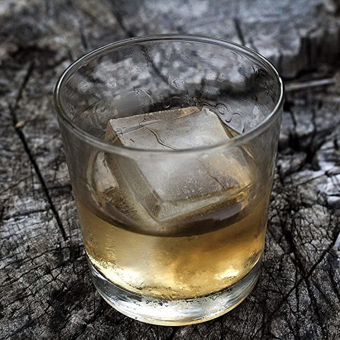 the large ice cube in a glass of whiskey