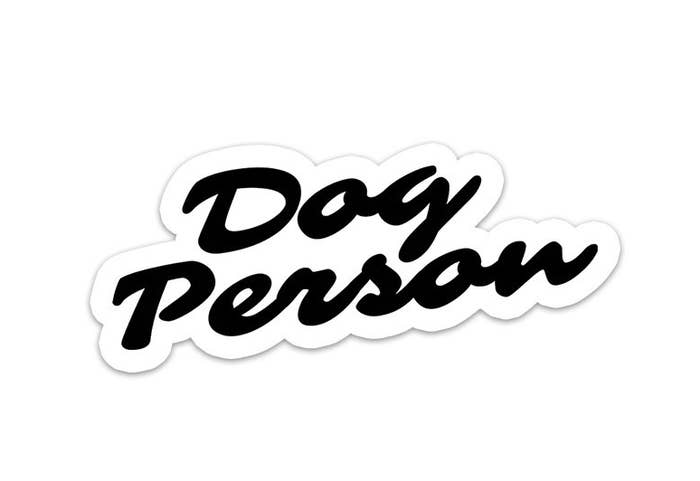 a white sticker with thick black cursive text reading &quot;dog person&quot;
