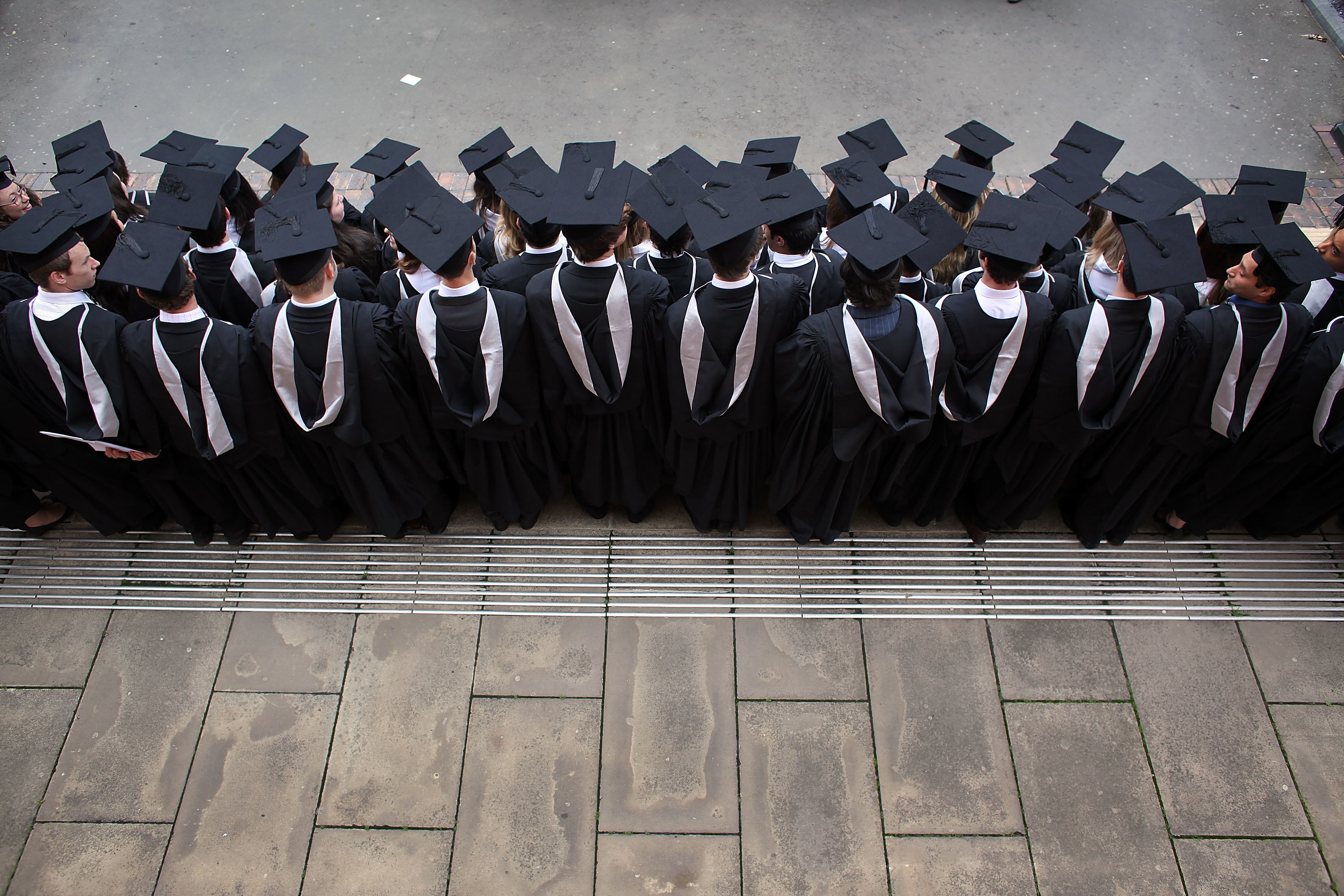 Students at the University of Birmingham in cap and gown pose for a group photograph as they take part in their degree congregations on July 14, 2009 in Birmingham, England.
