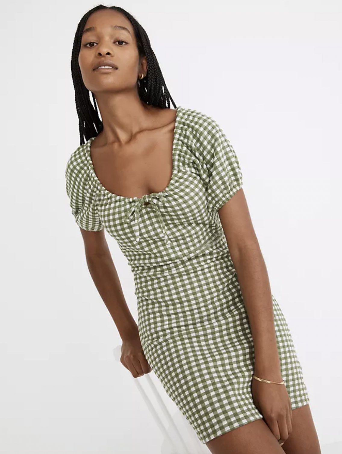 model wearing the green and white gingham dress
