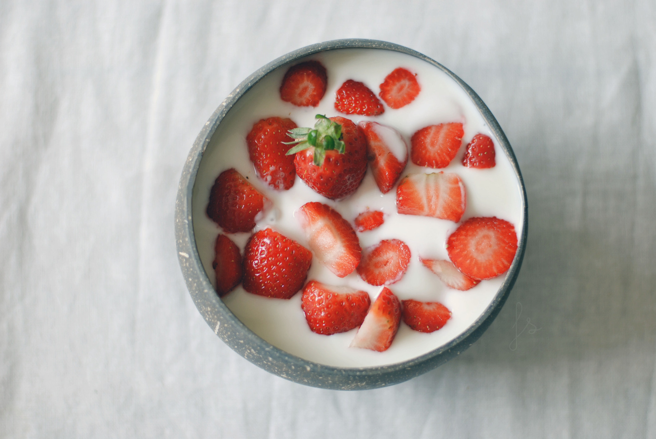 Strawberries in a bowl of yogurt