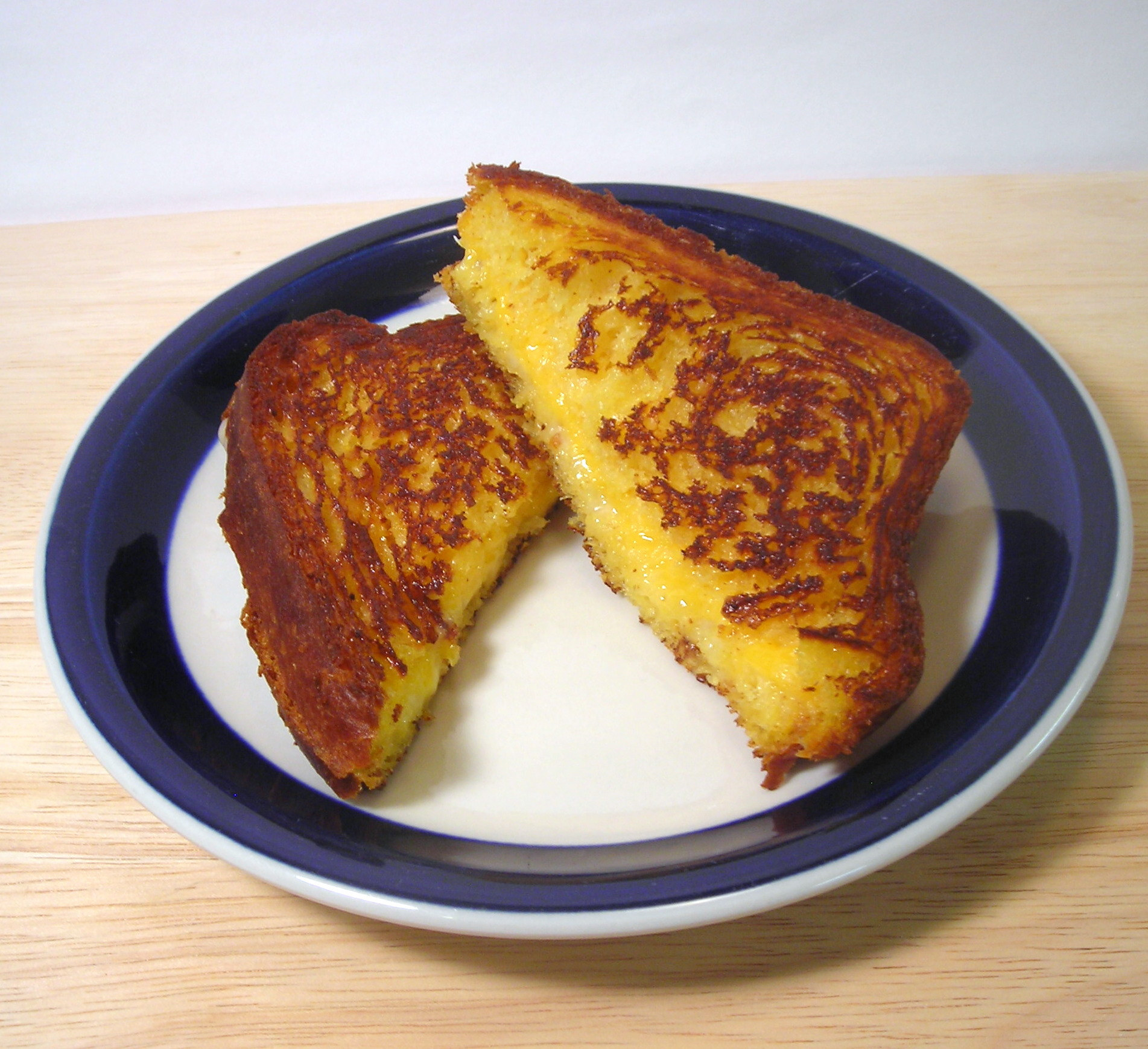 A grilled cheese sandwich sliced diagonally