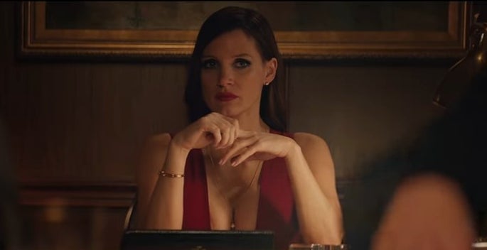 Molly sitting in a red dress in &quot;Molly&#x27;s Game&quot;