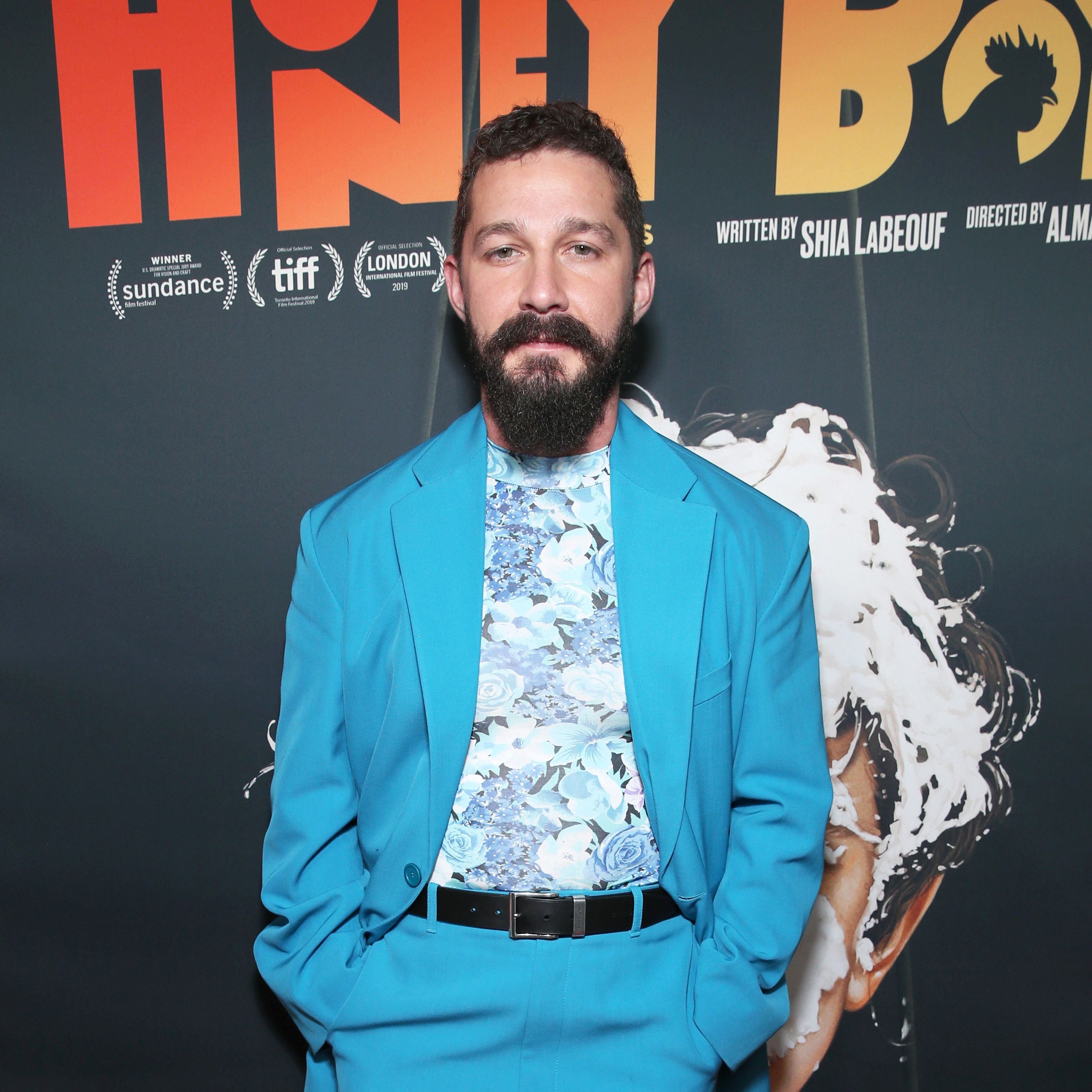 Shia on the red carpet wearing a suit and flowery shirt
