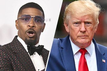 Jamie Foxx wears a black suit with a monochromatic print with red and white colors and a pair of blue aviators. Donald Trump wears a blue suit with a white undershirt and a red tie.