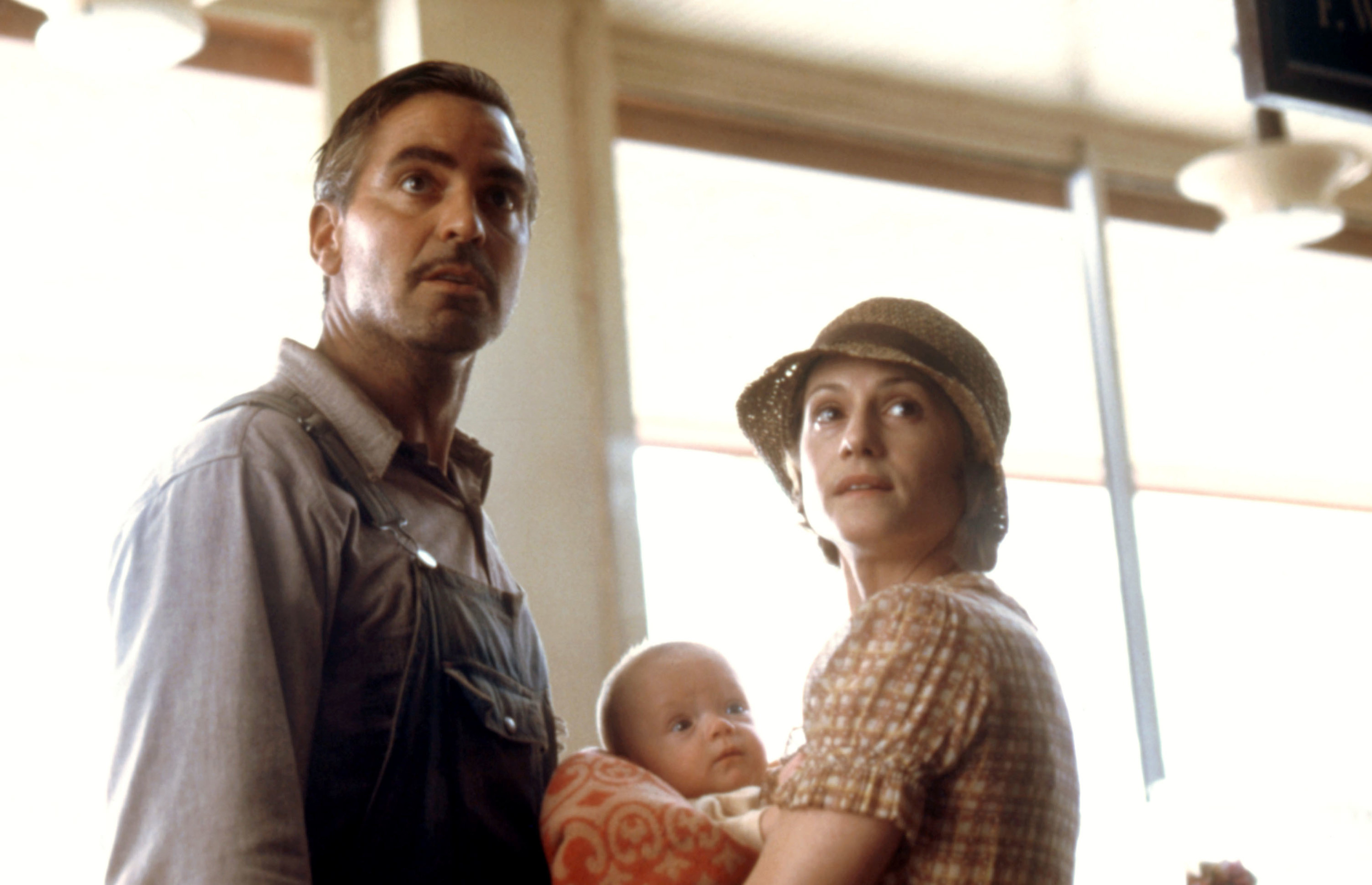 close up of george in a scene with a woman holding a baby