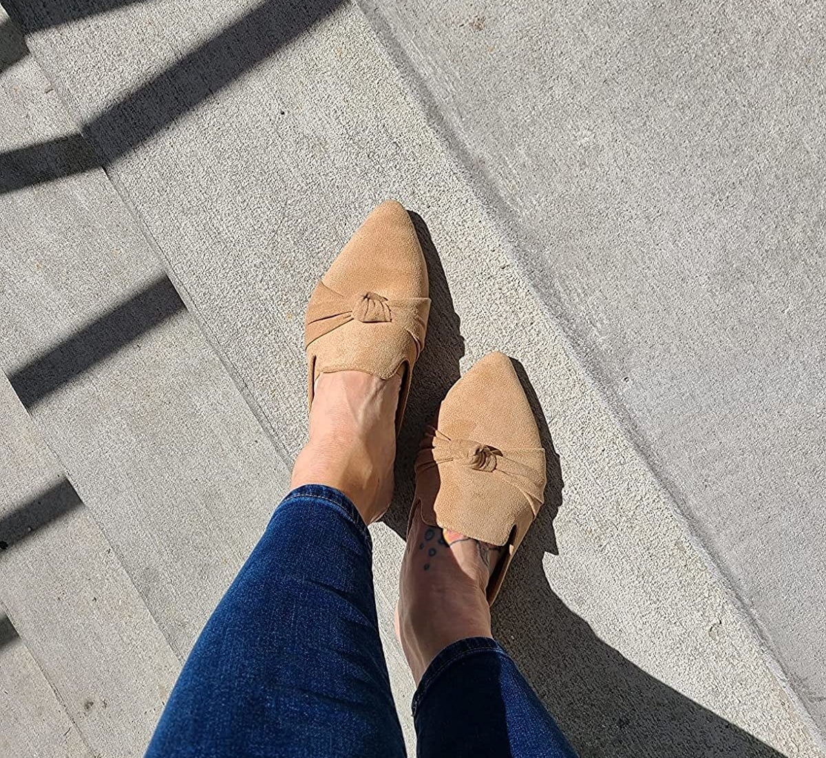 Reviewer wearing tan colored mules