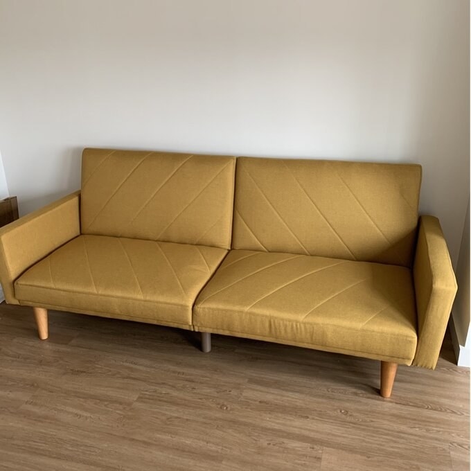 a reviewer photo of the mustard couch