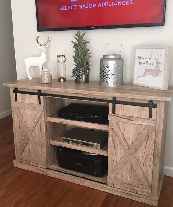 a reviewer photo of the light colored TV stand