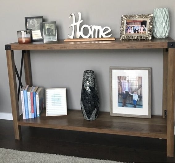 a reviewer photo of the console table with decor on it