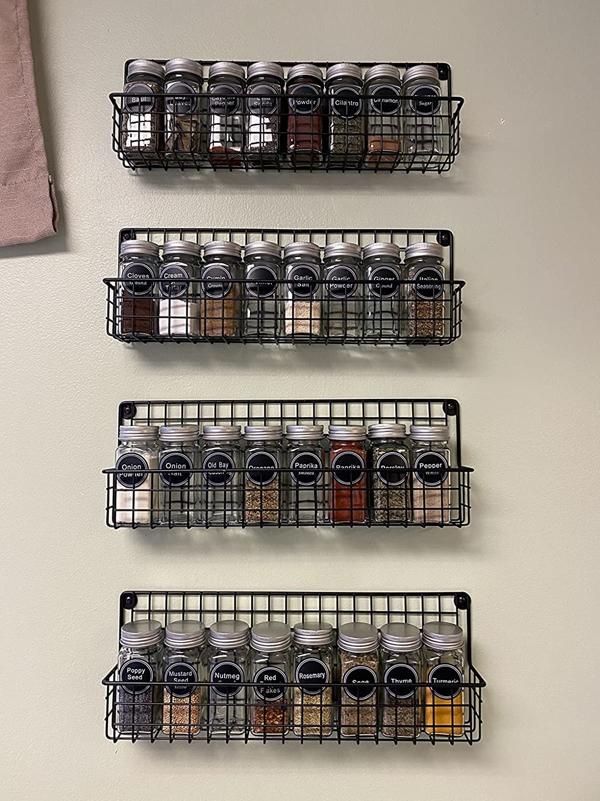 Reviewer image of four wire shelves filled with spice bottles
