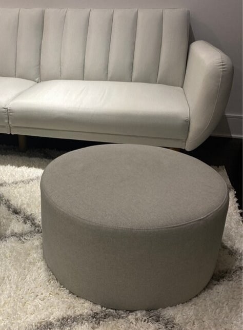 a reviewer photo of the gray ottoman