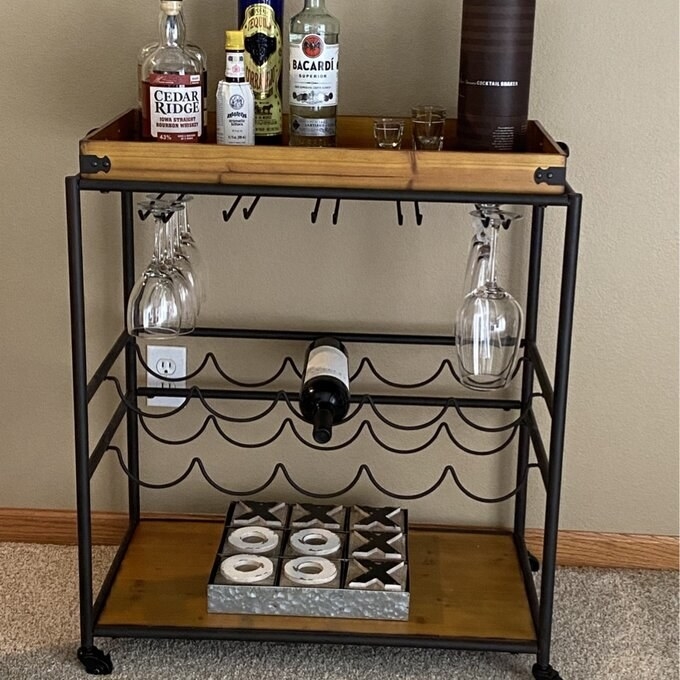 a reviewer photo of the wood and metal bar cart