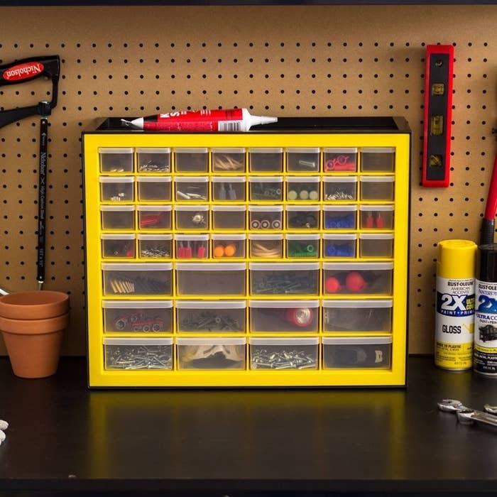 a yellow and black forty-four-drawer cabinet containing batteries, screws, and more