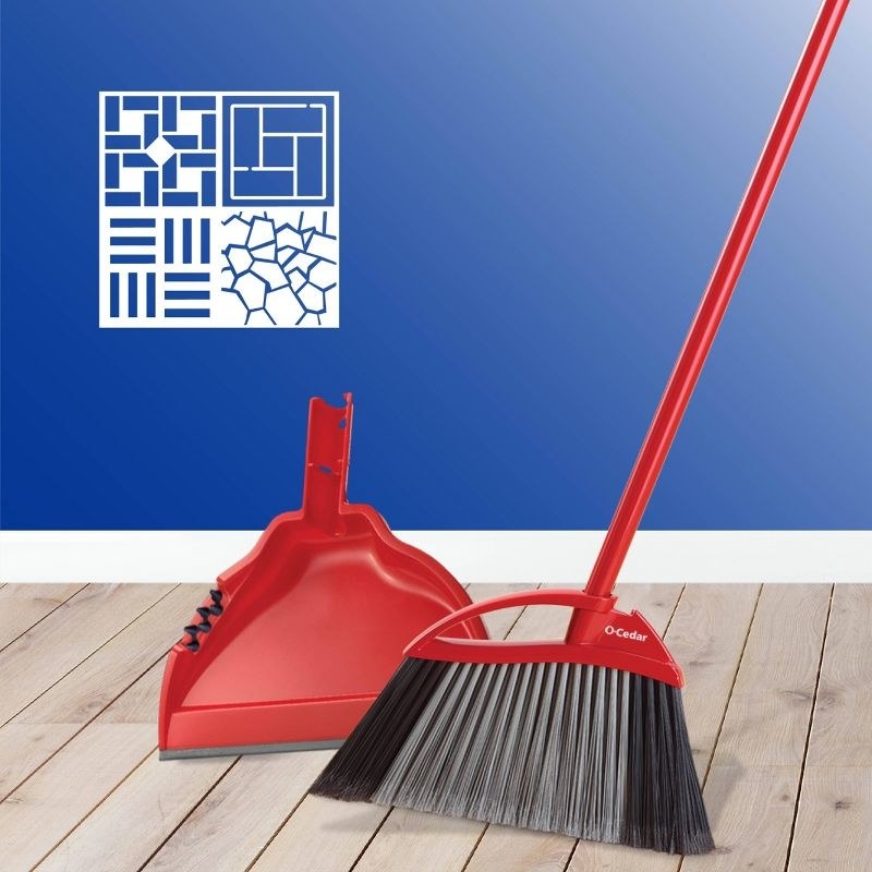 a red broom and dustpan on a hardwood floor