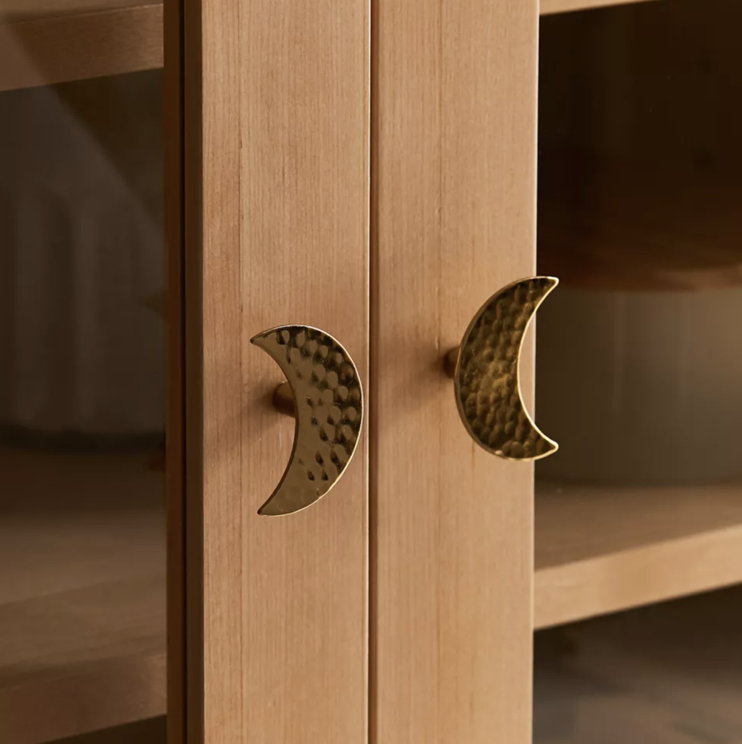 Two moon knobs on a dresser