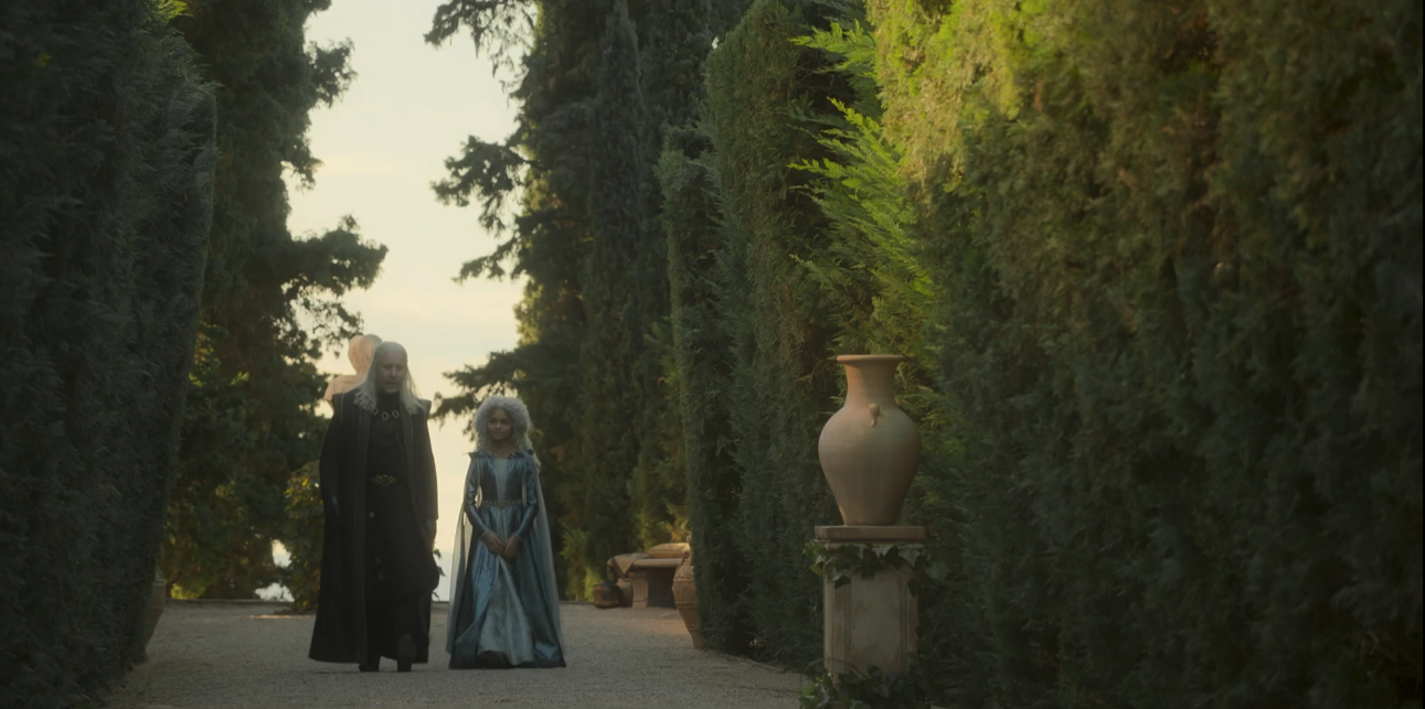 Viserys and Laena talking while walking the castle grounds