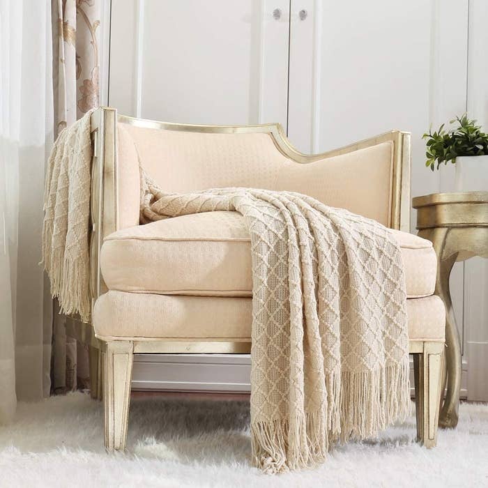 the throw draped over a love seat