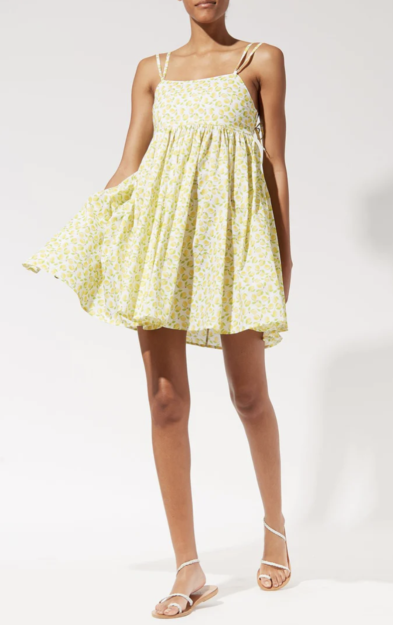 model wearing sandals and the heidi dress, a babydoll dress with a lemon pattern