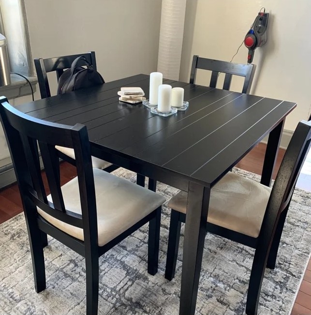 A reviewer&#x27;s image of the black four-person dining room set