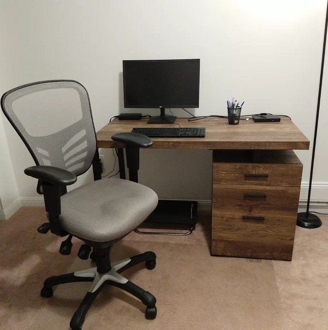 A reviewer&#x27;s image of a black/grey ergonomic task chair