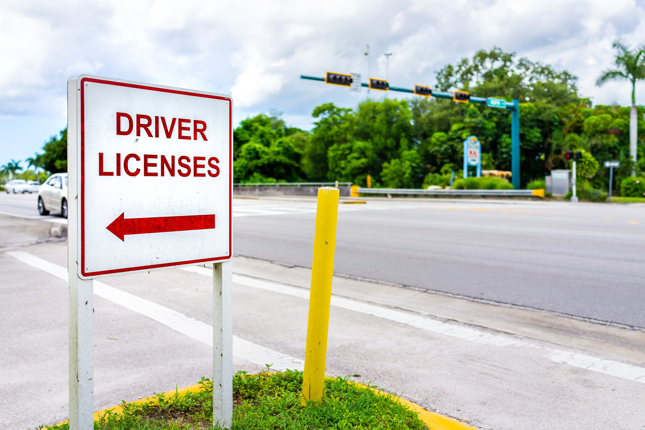 sign pointing to where to get a driver&#x27;s license